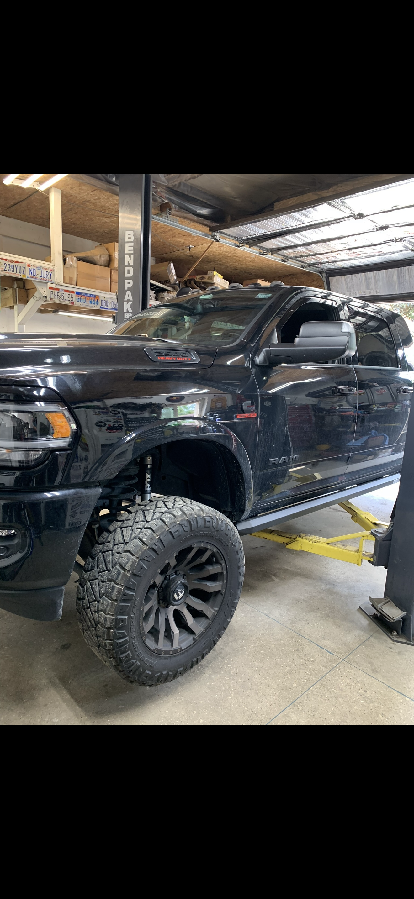 Kevin's lifted Ram Heavy Duty truck in the shop at Real Deal Automotive